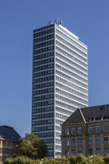 Fototapeta premium shoot of an office building and old buildings in front, with blu