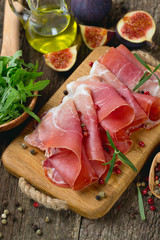 sliced prosciutto on a wooden board