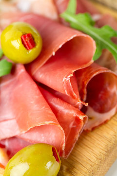 sliced prosciutto with stuffed olives