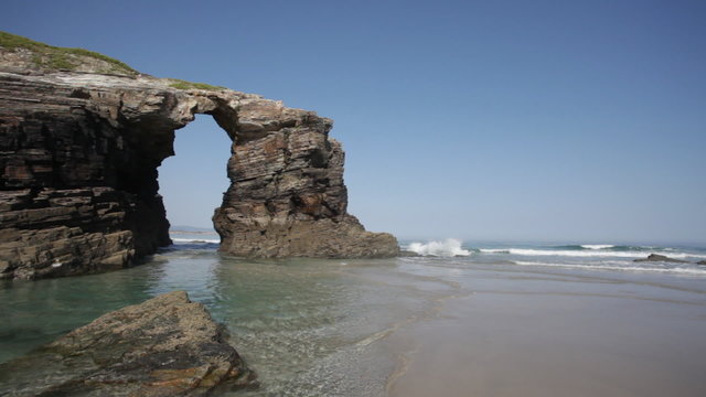 Stone arches on Playa de las Catedrales during outflow, Spain