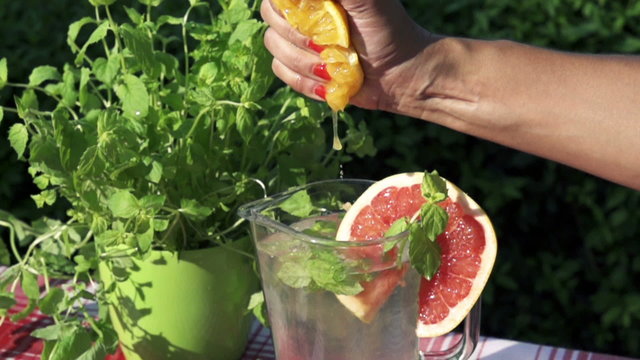 lemon squizing into the jug of water, slow motion shot at 480fps