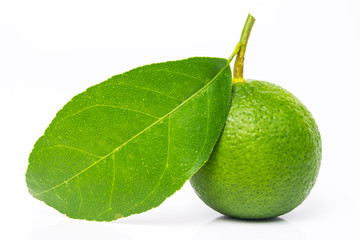 limes with green leaf. Isolated on white.