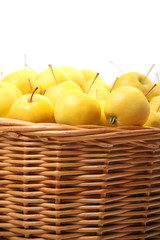 yellow apples in a wicker basket