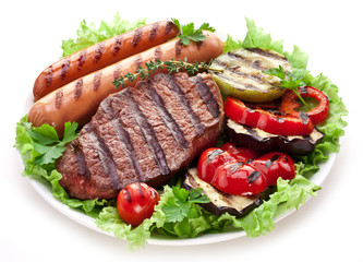 Grilled steak,sausages and vegetables.