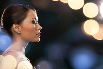 woman in evening dress wearing diamond earrings