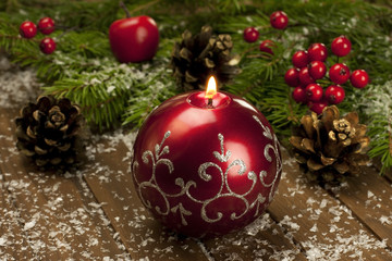 Christmas candle on a wooden surface
