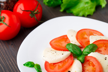 Tomato and mozzarella with basil leaves