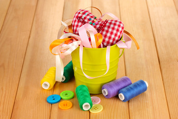 Color bucket with multicolor ribbons and thread