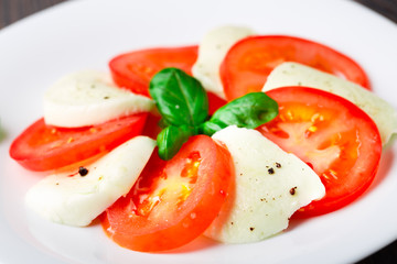 Tomato and mozzarella with basil leaves