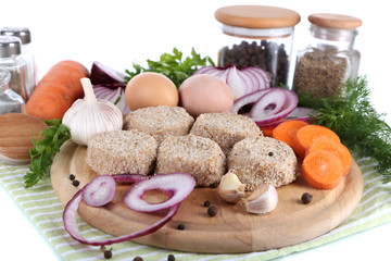 Meat patties on board on napkin  isolated on white
