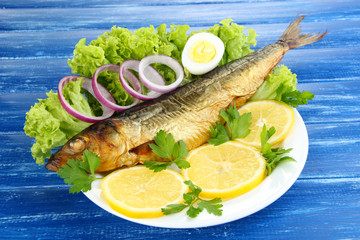 Smoked fish on plate close up