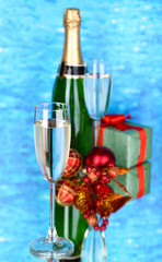 Bottle of champagne with glasses and Christmas balls