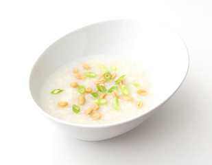 A bowl of Chinese congee on a white background