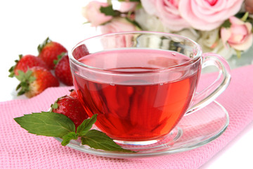 Delicious strawberry tea on table close-up