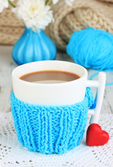 Cup with knitted thing on it close up