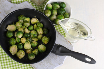 Fresh brussels sprouts in pan with vegetables and spices