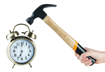 Hammer in hand and alarm clock isolated on white