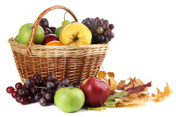 Different fruits with basket and yellow leaves isolated on