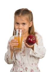 Little Girl Holds a Glass with an Apple Juice with One Hand and