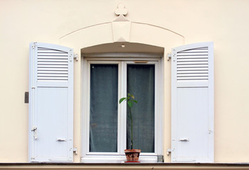 Window with shutters of old buildings in Paris.