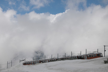 Gornergrat railway arriving at  station in Swiss Alps