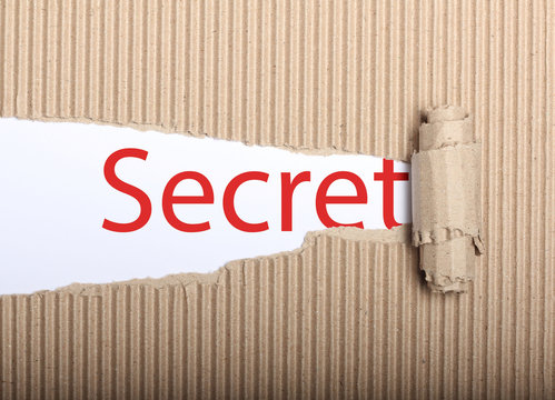 Secret text on paper and torn cardbox