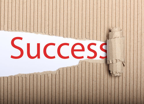 Success text on paper and torn cardbox