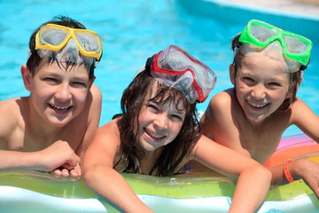Happy children in swimming pool