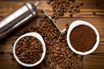 coffee beans with ground coffee and grinder