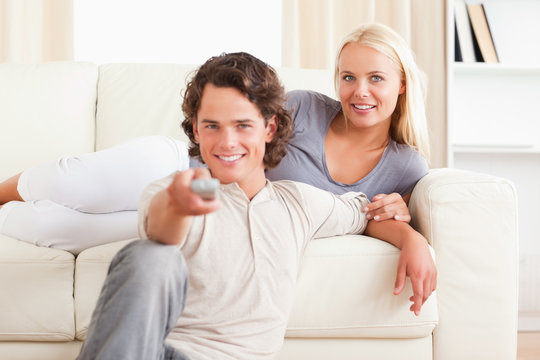 Lovely couple watching the television