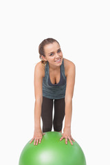 Fit woman supporting herself with a fitness ball