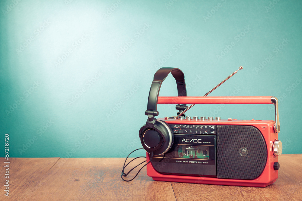 Wall mural Retro cassette player and phones in front mint green background