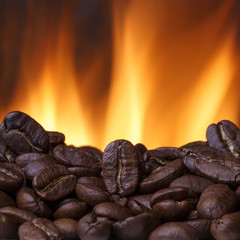 Coffee beans roasting with fire on background