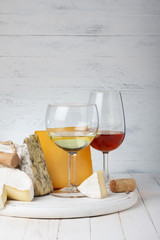 Cheese and wine on wooden table