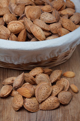 Raw almonds in shell on wooden table still life
