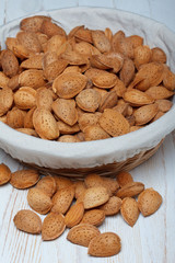 Raw almonds in shell on wooden table still life