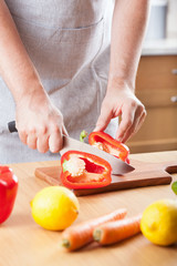 Obraz na płótnie Canvas man cutting paprika