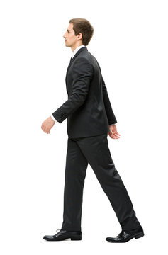 Full-length profile of walking businessman, isolated