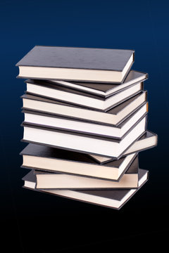 Stack of hardcover books on a color background