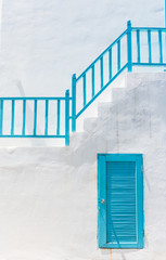 blue door  on white wall and blue Staircase