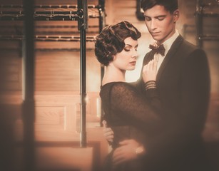 Beautiful vintage style couple inside retro train coach