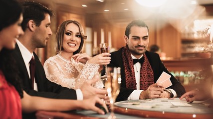 Group of young people playing poker in a casino