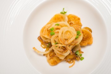 Fried pieces of fish on white plate