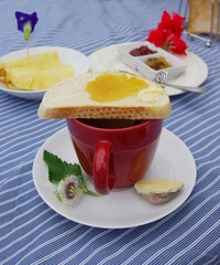 A red cup of coaco and bread ,break fast