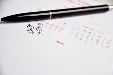 parents expecting twins marked date into calendar