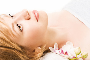 woman in spa salon lying on the massage desk