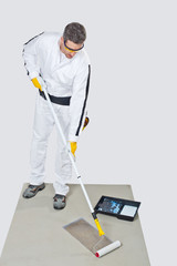 Worker Paint With Primer Concrete Floor For Waterproofing