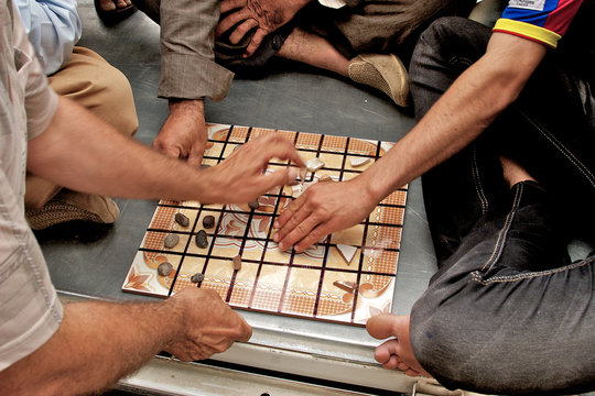 People playing traditional board game, Arbil, Iraq