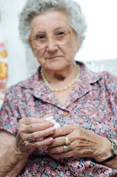 Portrait of a senior woman taking pill