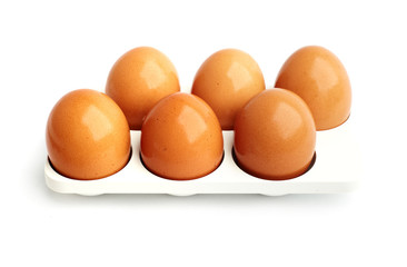 six eggs in a tray on white background